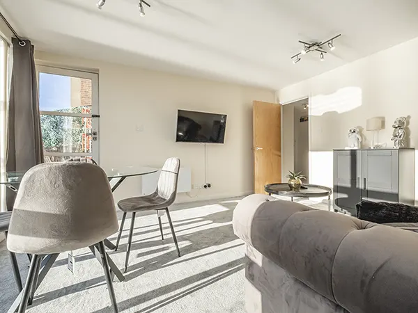 Bright, well-lit living room showcasing common real estate photo challenges addressed.