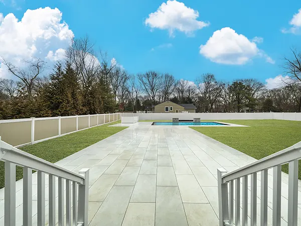 Spacious backyard with pool, enhanced by expert real estate photo editing.