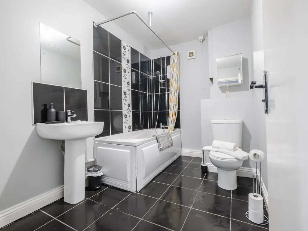 Clean, bright bathroom showcasing real estate photo editing details.