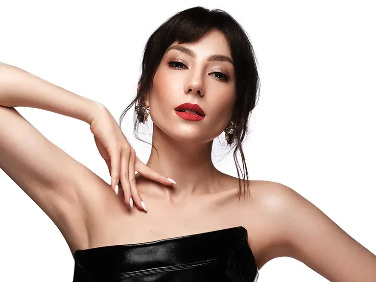 A retouched portrait of a beautiful woman in a black strapless top, showcasing clear skin and enhanced features, advertising photo editing services.